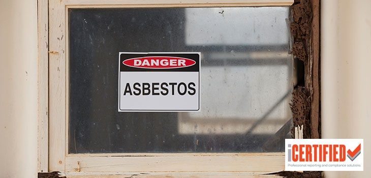 asbestos warning sign on the window of an old building