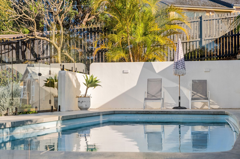 backyard pool with glass fencing